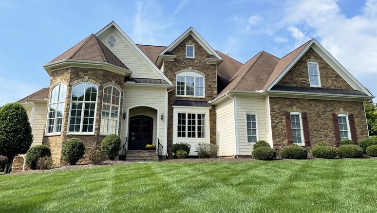 Weatherguard Roofing & Restoration | A newly renovated home with a freshly cut lawn and a new roof